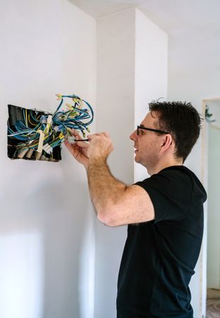 Electrician working on the electrical installation of a house