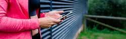 Unrecognizable female athlete with mobile phone