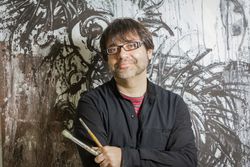 Painter artist posing in front of paint