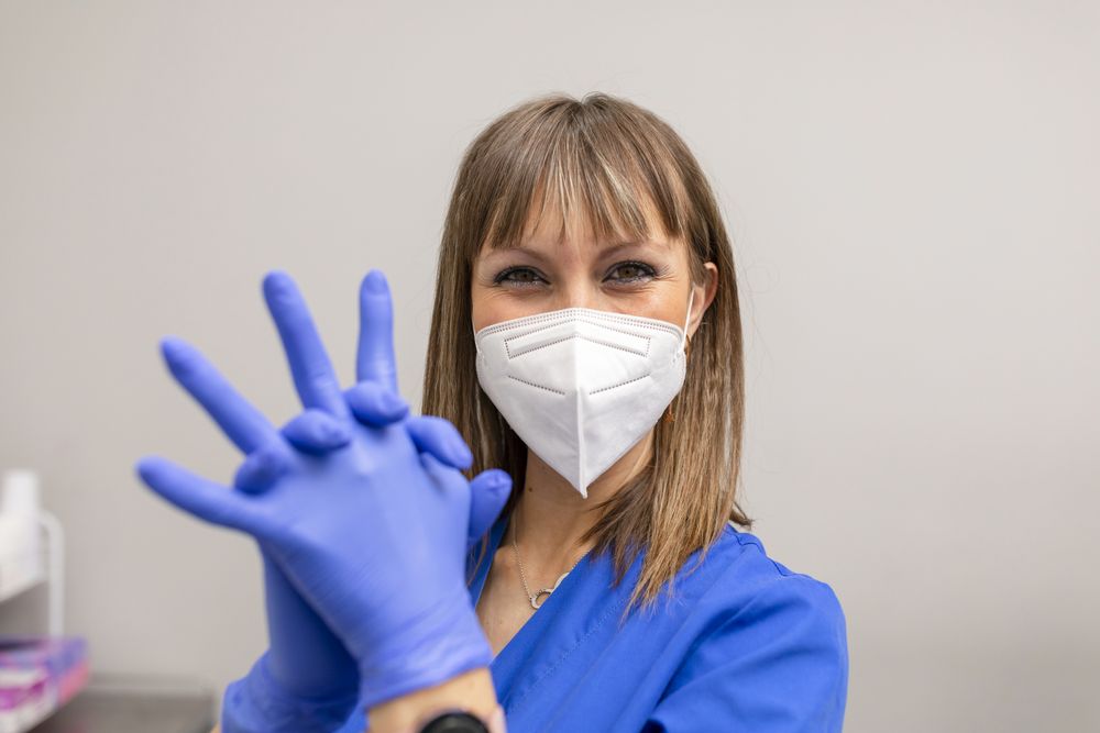 Dentist in face mask and latex gloves