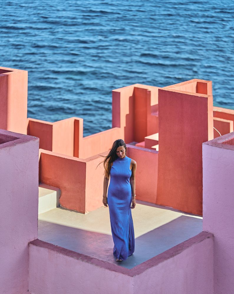 Woman in blue fur dress on the roof of a building