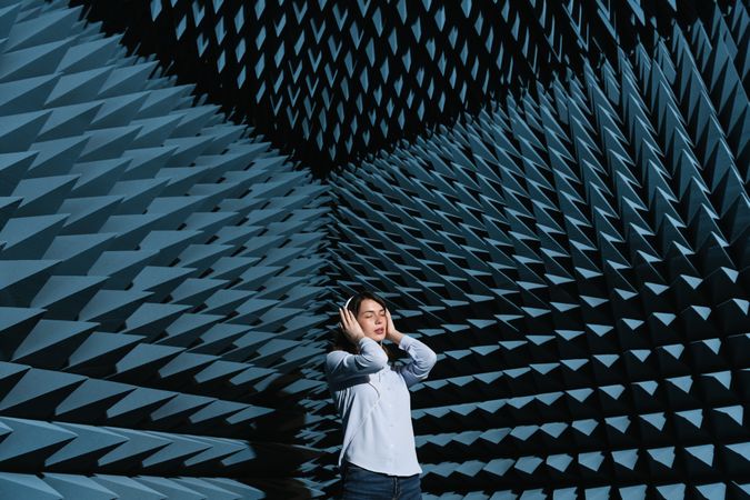 Woman in sound room listening to music
