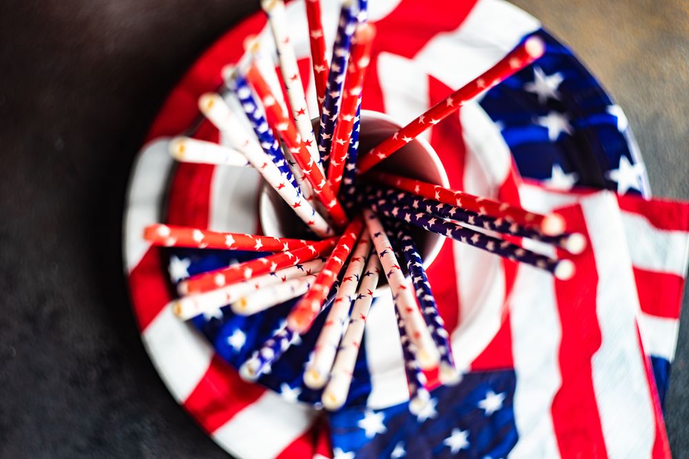 Looking down at American flag plates, napkins and straws