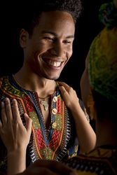 Black man smiling looking to hugging woman