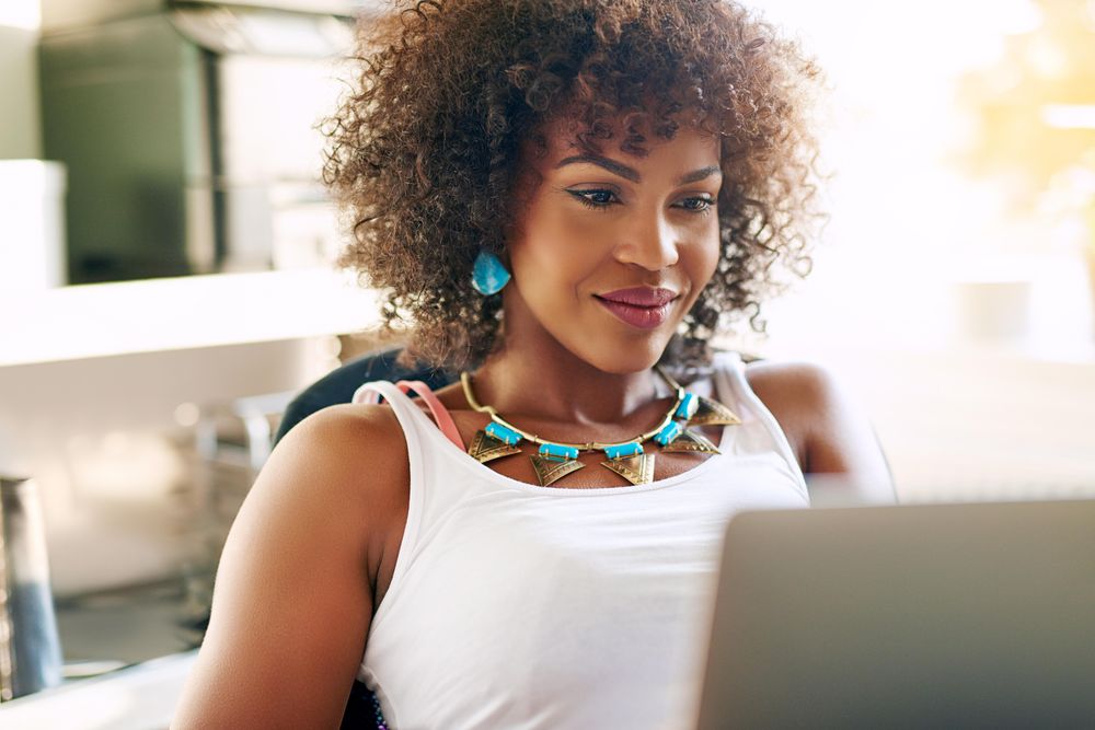 Female entrepreneur sitting in front of her laptop at home