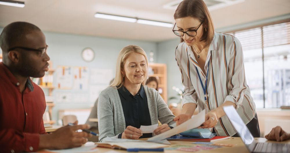 Positive Female Teacher Giving Advice, Answering Questions and Motivating Students