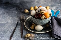 Easter table setting with bowls of different sized eggs with space for text bxAqwj