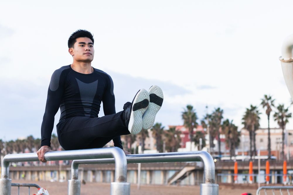 Sportsman exercising on parallel bars
