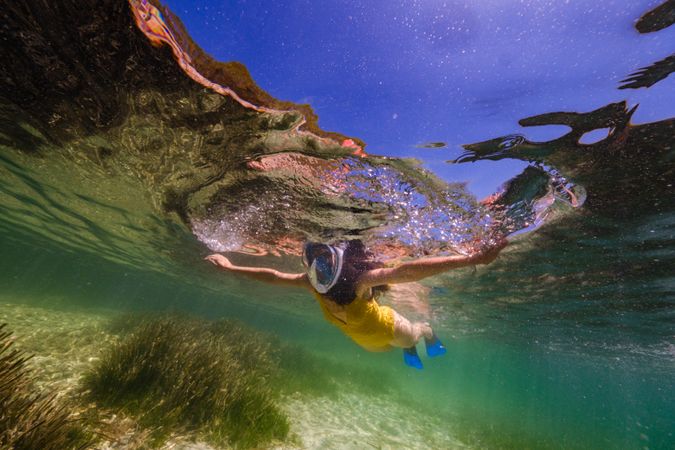 Unrecognizable person swimming in sea