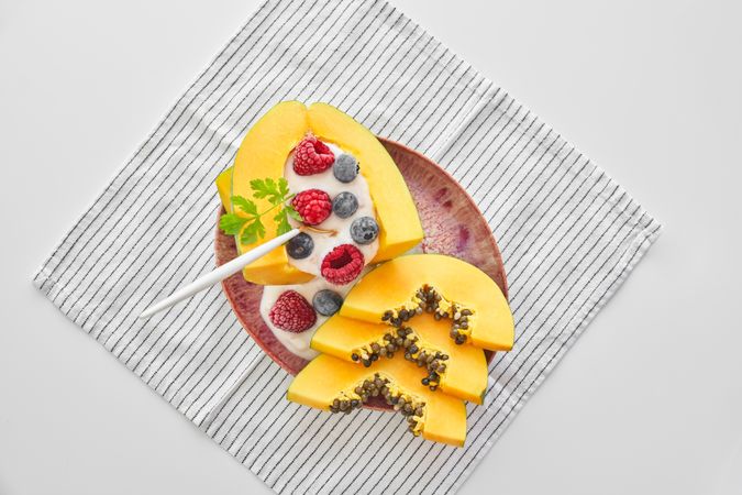 Portion of yummy papaya bowl with berries
