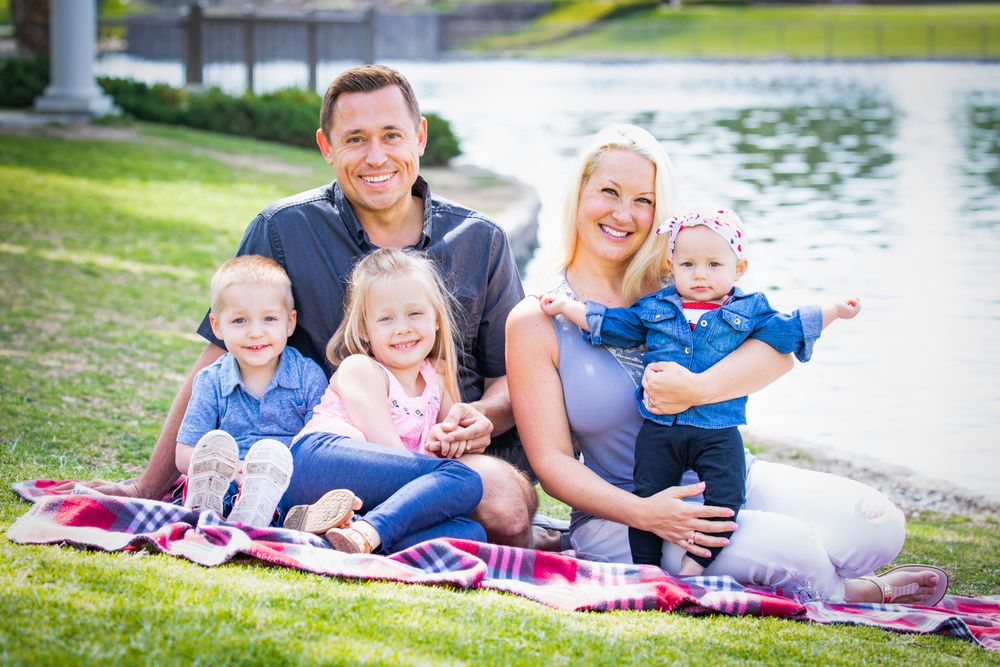 Happy Young Family Portrait In The Park