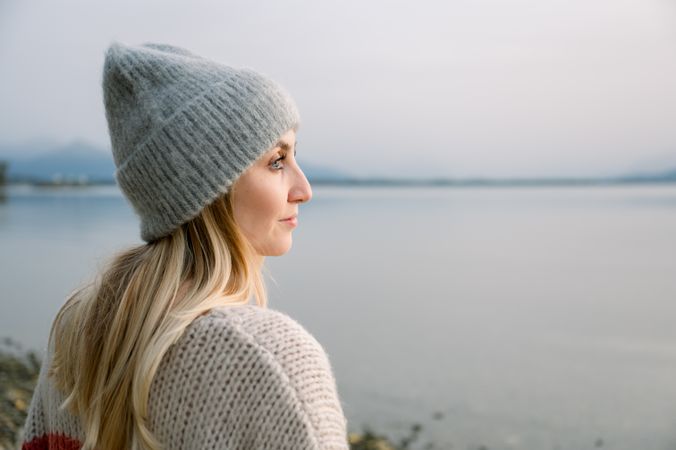 Side view of woman looking away against lake