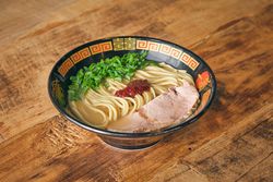 Delicious ramen with chopped scallions on table