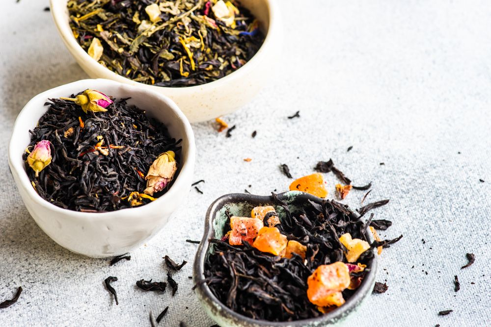 Fruity tea varieties on stone background