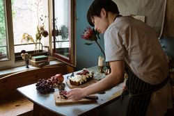 Man preparing cake in kitchen