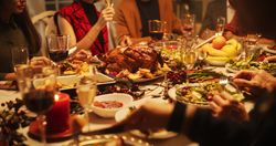 Merry Family Members Enjoy a Festive Meal, Share Food Around the Table and Having Funny Conversations and Happiness During a Christmas Turkey Dinner.