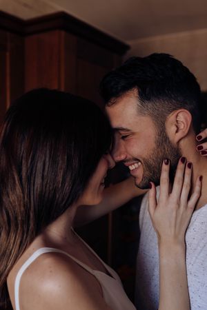 Happy couple embracing in kitchen