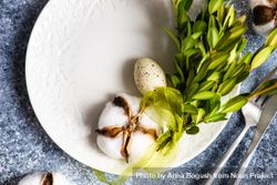 Top view of Easter table setting with branch, cotton and decorative eggs bxAq8v