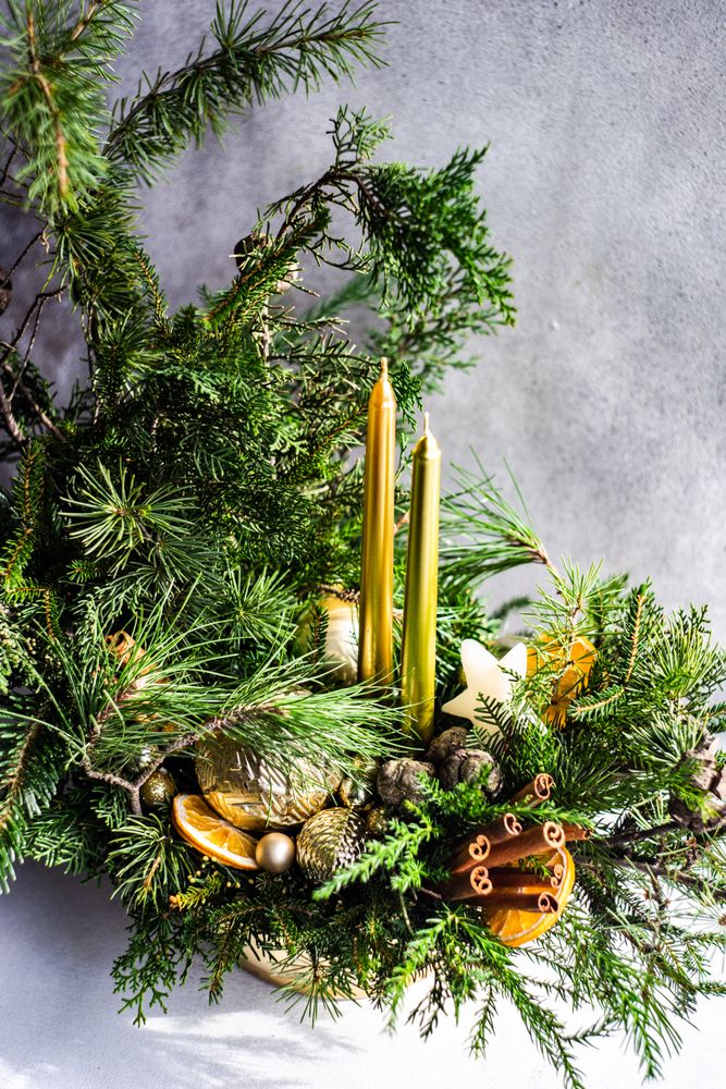 Holiday center piiece with candles and cinnamon sticks