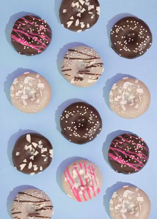 Flat lay of doughnuts on blue background