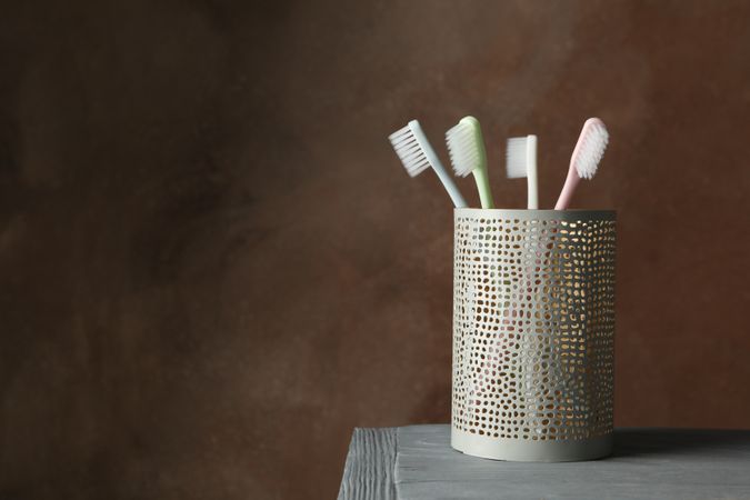 Tools for dental care on brown background, space for text