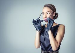 Vintage fashion model putting on sunglasses
