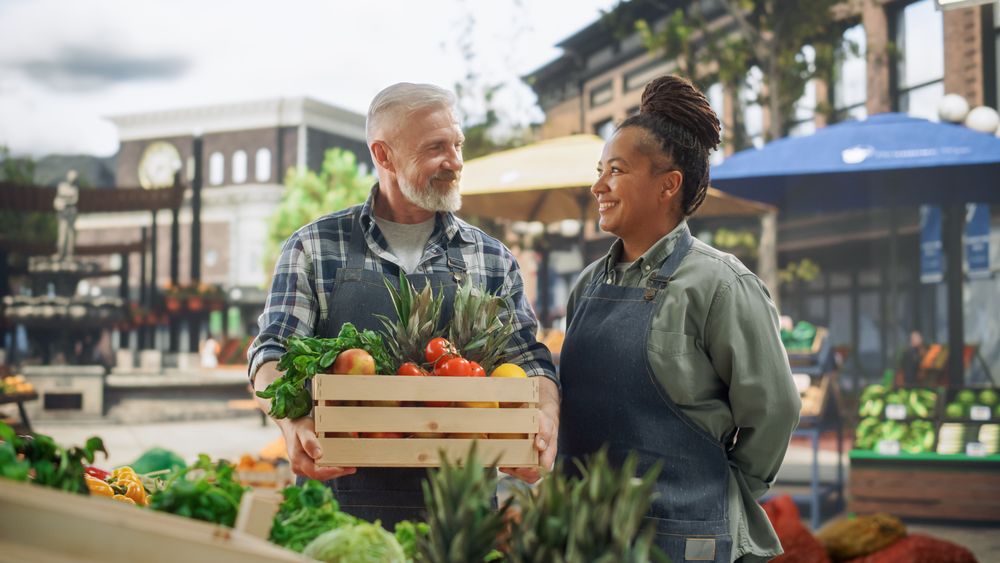 Portrait of a Happy Multiracial Street Vendors Couple Posing for Camera and Smiling.
