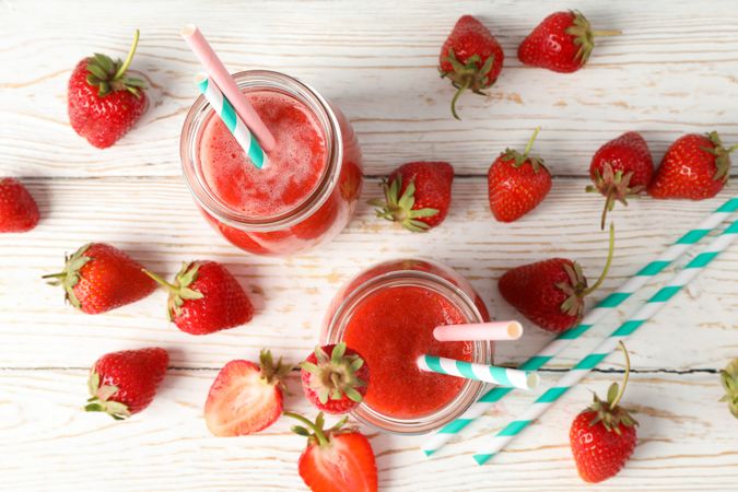 Composition with strawberry cocktails on wooden table. Summer berry