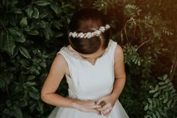Bride in charming dress admiring finger ring in garden