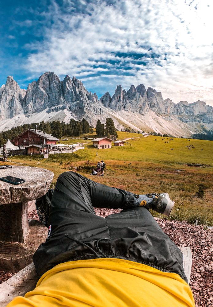 Man lying near houses in The Puez-Geisler Nature Park