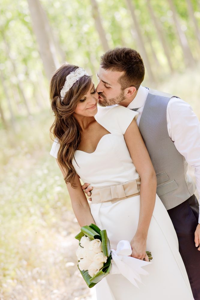 Newlyweds being affectionate in poplar forest