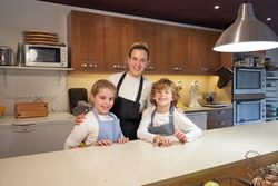 Happy mother and children in kitchen