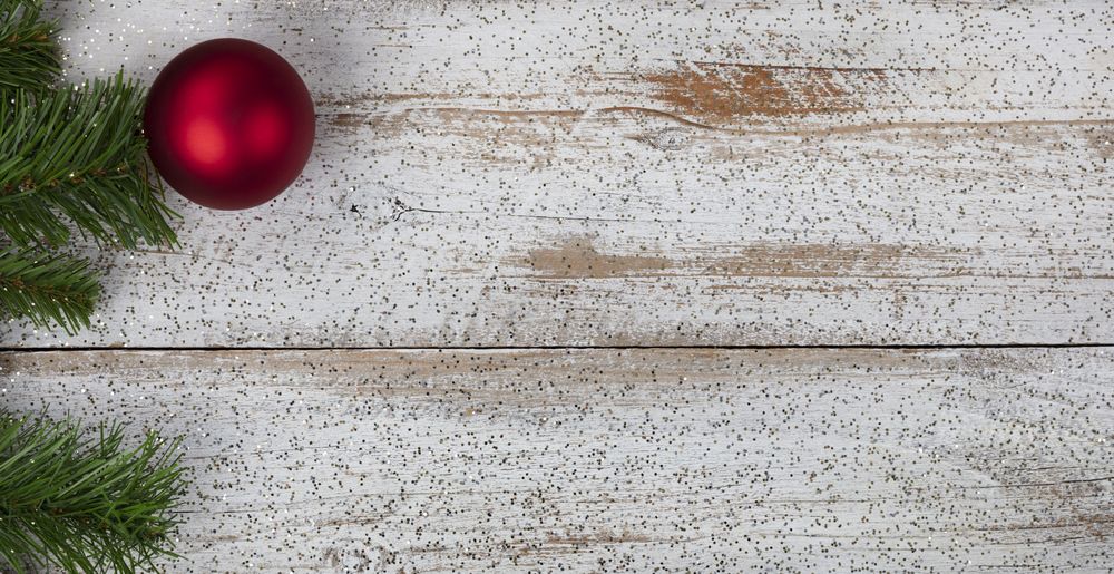 Single red ornament on rustic wood for Christmas or New Year holiday concept background