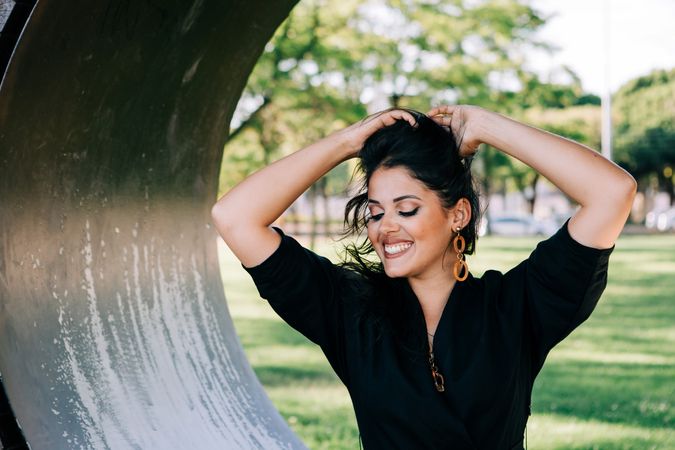 Young female relaxing on wooden round bench