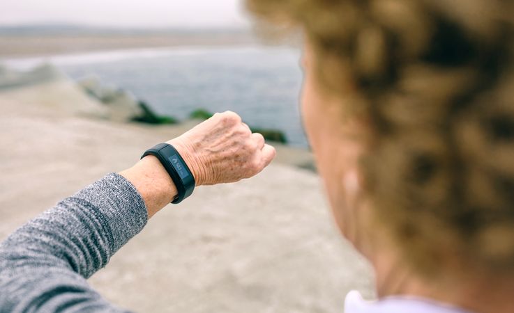 Mature woman looking smart watch