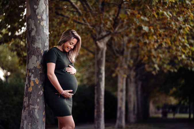 Pregnant woman standing in garden