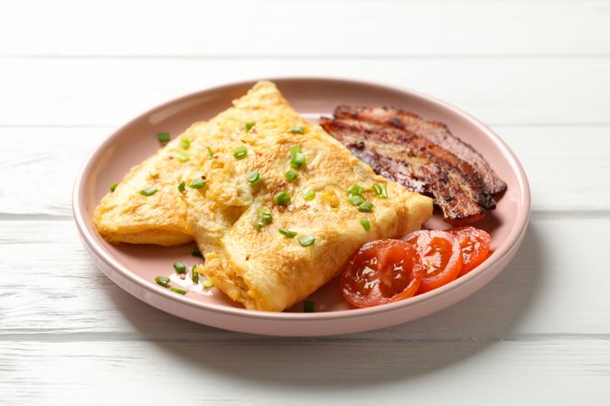 Breakfast of scrambled eggs, on pink plate