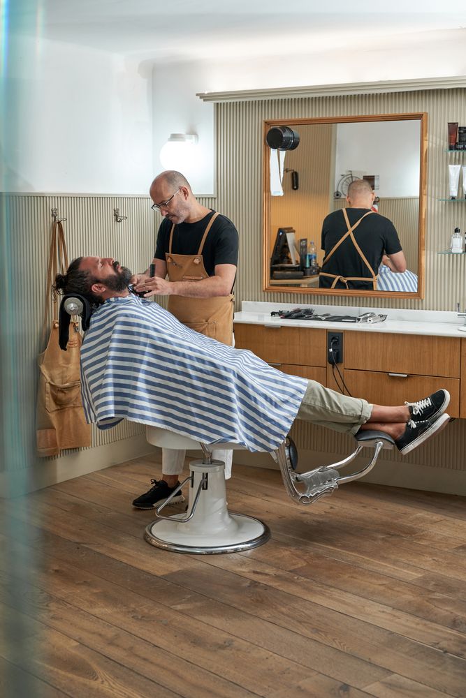 Professional barber cutting hair of client