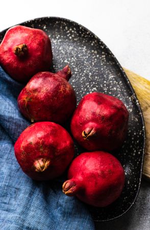 Top view whole pomegranate on ceramic plate