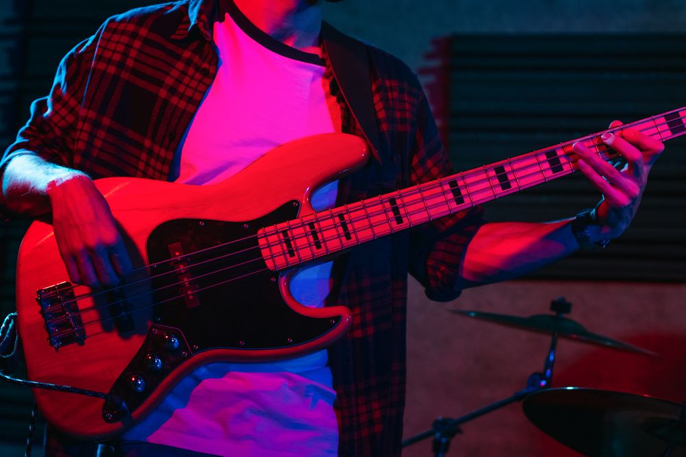 Bass Player Performing In A Live Concert