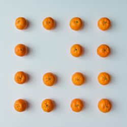 Pattern of tangerines on light  background