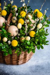 Easter card concept with fresh basket of greenery with decorative eggs