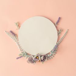 Creative layout made with spring flowers and leaves on pastel pink background