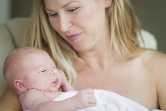 Mother Holding Her Precious Newborn Baby Girl