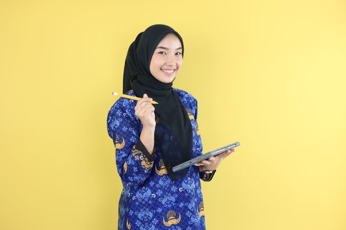 Cheerful Muslim Woman in Blue Korpri Batik Uniform