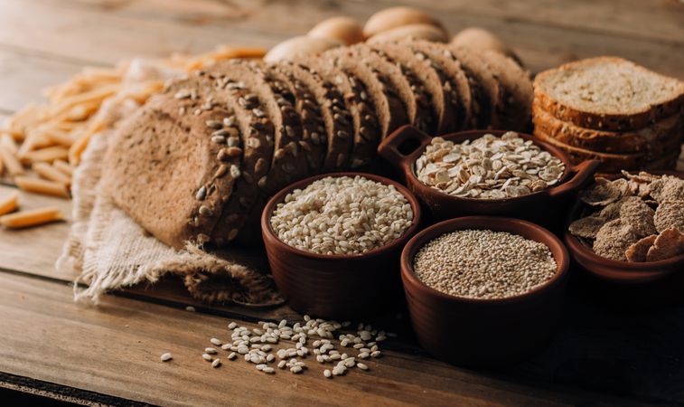 Wholegrain food pasta and freshly baked rye bread on table