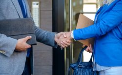 Businessman and businesswoman giving a handshake