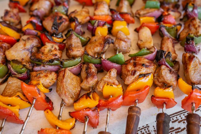 top view of plate with skewers sticks of pork with vegetables