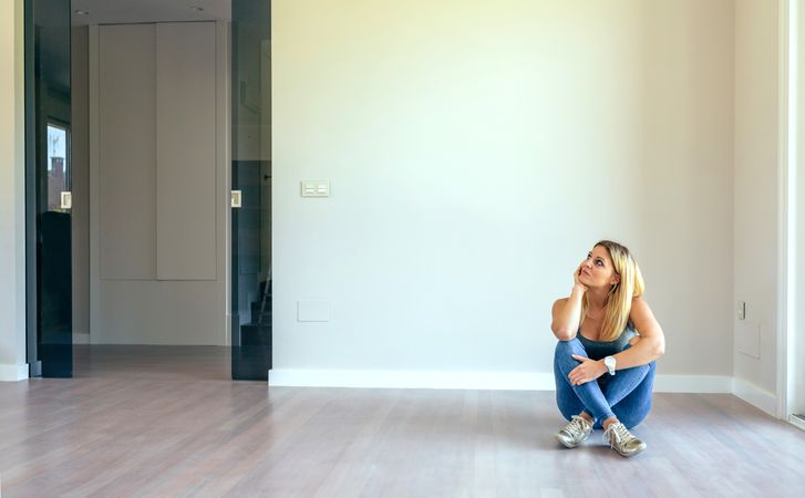 Thoughtful woman sitting in a living room