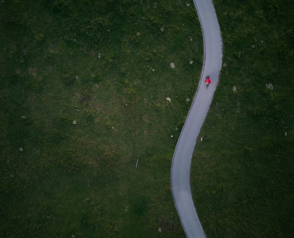 Aerial view of a man biking on a wavy path